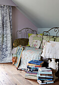 Stack of books and daybed in attic