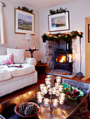 Christmas garlands with wood burning stove and ornate candle tea light holder