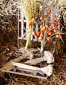 Dried flowers and metal chair in hay barn Essex England UK
