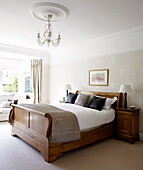 Double sleigh bed in bedroom of Harrogate home Yorkshire England UK