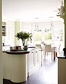 Cut flowers on worktop in open plan kitchen in Harrogate home Yorkshire England UK