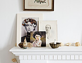 Black and white vintage photographic prints on mantlepiece in living room in Hastings home, East Sussex, UK