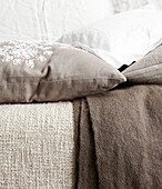 Assortment of fabrics in light browns and whites in Hastings home, East Sussex, UK