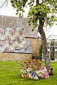 Floral fabric hanging on washing line in garden of rural Oxfordshire home, England, UK