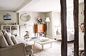 Painted white coffee table with vintage wooden cabinet in living room, Oxfordshire home, England, UK