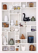 Selection of ornaments in wall shelf in Bussum home, Netherlands