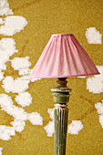 Standard lamp in room with blossom patterned wallpaper, Amsterdam, Netherlands