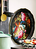 Floral black tray with ladles and fruitbowl in kitchen of contemporary apartment, Amsterdam, Netherlands