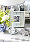 White rose with glass lampstand and antique silver comb and hand mirror on dressing table in Oxfordshire, England, UK