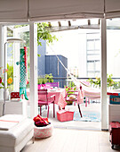 Table and chairs with hammock on outdoor terrace of Mattenbiesstraat family home, Amsterdam, Netherlands