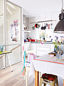 Sunlit kitchen with pans hanging at window, Mattenbiesstraat, Netherlands