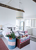 Large lampshade hangs over double bed in Devonshire country home UK