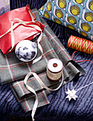 Fabric samples with Christmas ribbon and bauble in London home England UK