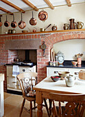 Freigelegter Ziegelsteinkamin mit Kupferpfannen in der Küche eines Bauernhauses in Derbyshire England UK
