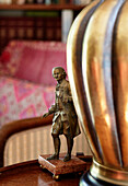 Brass lamp base and figurine of a gentleman in traditional country house Welsh borders UK