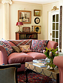 Embroidered cushions and artwork in living room of traditional country house Welsh borders UK