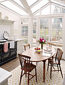 Oval table and black AGA in conservatory kitchen extension Bicester Oxfordshire England