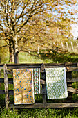 Fabric samples on wooden fence in Northumberland England UK