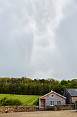 Cloudy sky above wood clad Hexham house Northumberland UK