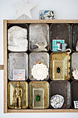 Collection of old storage tins with tiny animal ornaments in Birmingham home England UK