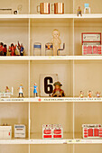 Dolls house furniture and figurines with number 6 on shelf in Country Durham home, North East England