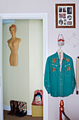 Naked mannequin and cowboy boots with embroidered turquoise shirt in County Durham home, North East England, UK
