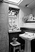 Chinaware ornaments and pedestal basin in Powys cottage bedroom, Wales, UK