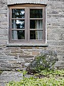 Wooden window on stone exterior of Herefordshire farmhouse, UK