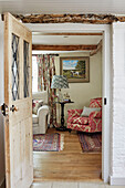 Blick durch eine Bleiglastür auf einen Sessel und einen Beistelltisch in einem Haus in Berkshire, England, UK