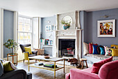 Decorative fireplace in colourful living room of Deddington home, Oxfordshire, UK