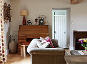 Antique telephone on wooden writing desk with tweed sofa in Northumberland farmhouse, UK