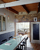 Cake stand on table with blackboard and exposed stone in Brittany cottage, France