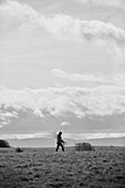 Woman walking near Offas Dyke path in rural Radnorshire-Herefordshire borders, UK