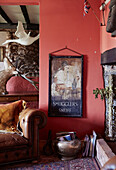 Vintage poster and books with Chesterfield at fireside in Devon home, UK