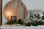 Chopping boards and cut foliage in West Sussex kitchen, UK