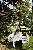 Tisch und Stühle unter einem Apfelbaum in North Yorkshire, UK