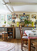 Chair and table with pinboards and lamps in Oxfordshire kitchen, UK