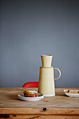 Ceramic jug and cake on wooden table in Sligo newbuild, Ireland