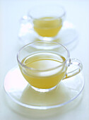Green tea in glass cups and saucers