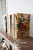 Vintage children's books on mantlepiece in Colchester family home, Essex, England, UK