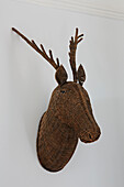 Wicker wall-mounted animal head in Colchester family home, Essex, England, UK