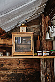 Kitchen detail with rustic larder and coffee grinder in Wooden cabin situated in the mountains of Sirdal, Norway