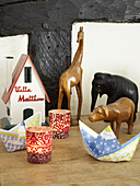 Wooden ornaments and tealights with model house in Herefordshire cottage, England, UK