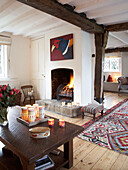 Lit fire in Herefordshire cottage, England, UK