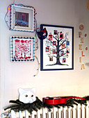 Child's artwork and letters spelling 'OPIELIA' above radiator in family home, France