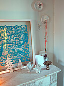 White ceramic ornaments with turquoise artwork on mantlepiece in family home, France