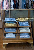 Clothes in display cabinet in store
