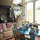 Kitchen with oven and dining table set for breakfast