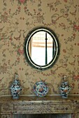 Decorative china on fireplace with mirror