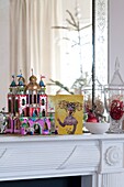 Christmas card and decorations on mantlepiece